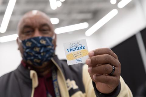 photo of man with vaccine sticker